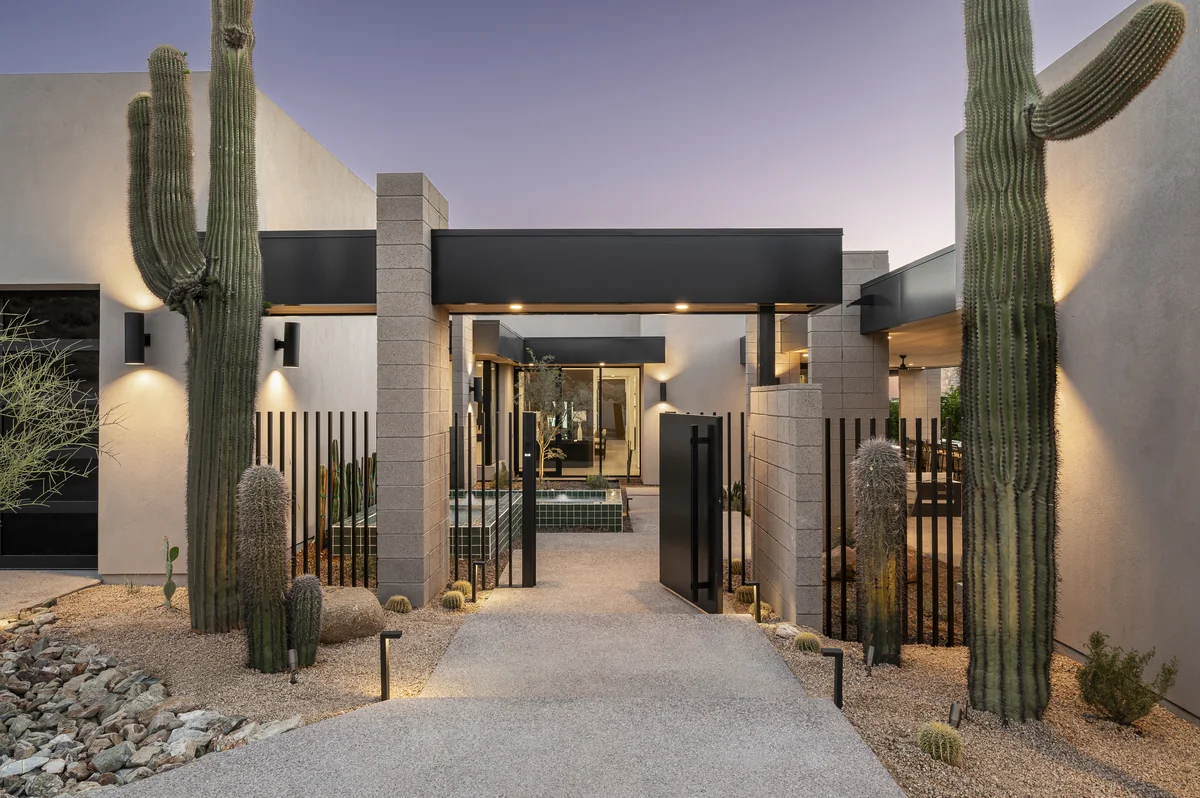Entry courtyard at Glenn Moor at dusk, framed by two saguaros