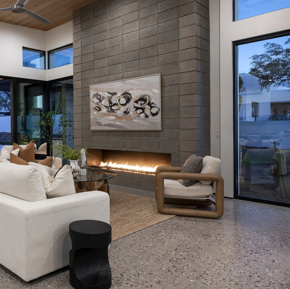 Great room at La Posada with linear fireplace and masonry wall