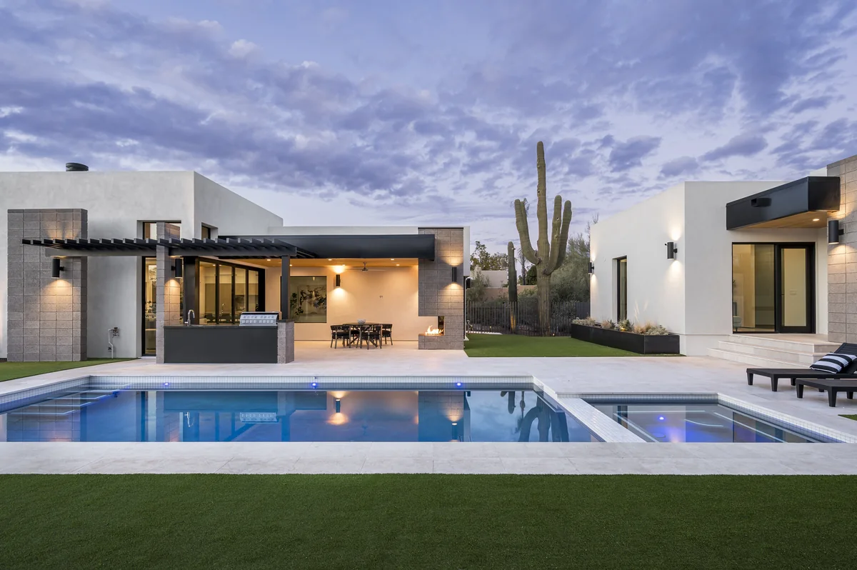 La Posada at dusk, with pool, lawn and saguaro
